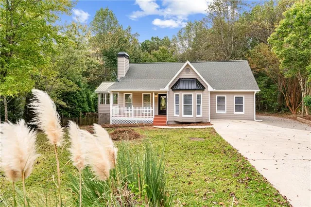 a front view of house with yard and green space