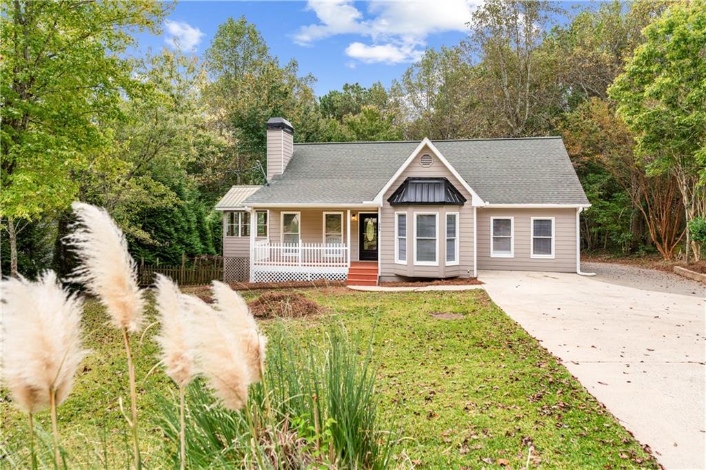 a front view of house with yard and green space