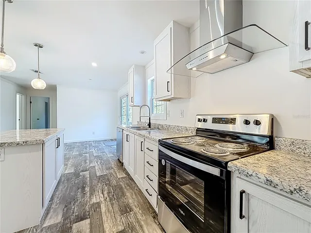 a kitchen with a stove and a sink