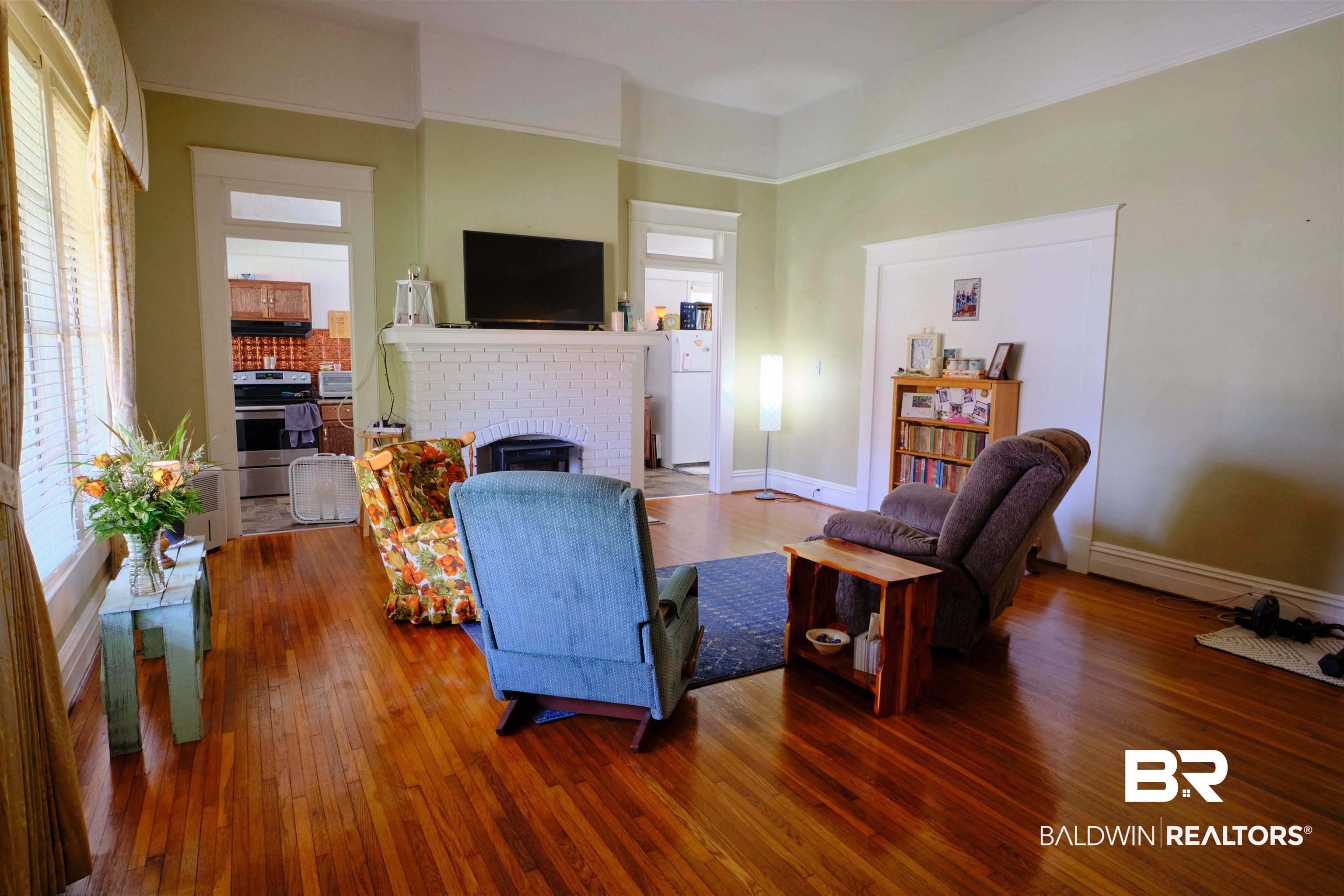 101 West Horner Street Atmore, AL 36502 - Photo 27 of 38 Living room with a fireplace and hardwood / wood-style floors