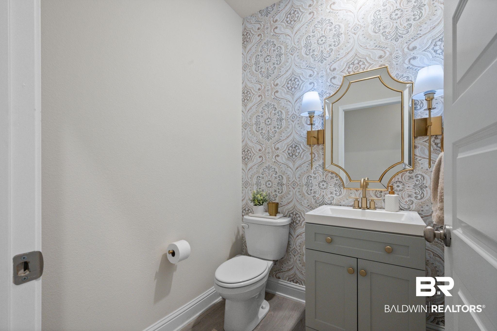 681 Calibre Street Fairhope, AL 36532 - Photo 38 of 56 Bathroom featuring vanity, toilet, and hardwood / wood-style floors