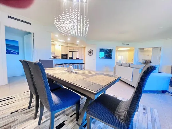 a view of a dining room with furniture and chandelier
