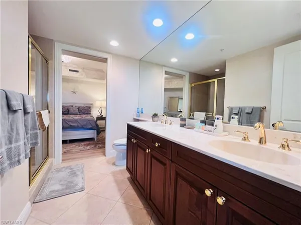 a bathroom with a double vanity sink and a mirror
