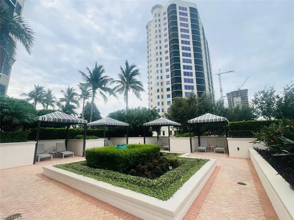 a front view of a house with swimming pool and sitting area