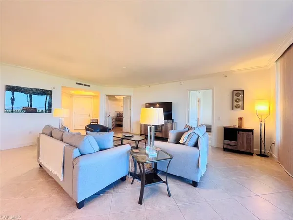 a living room with furniture a lamp a table and a window