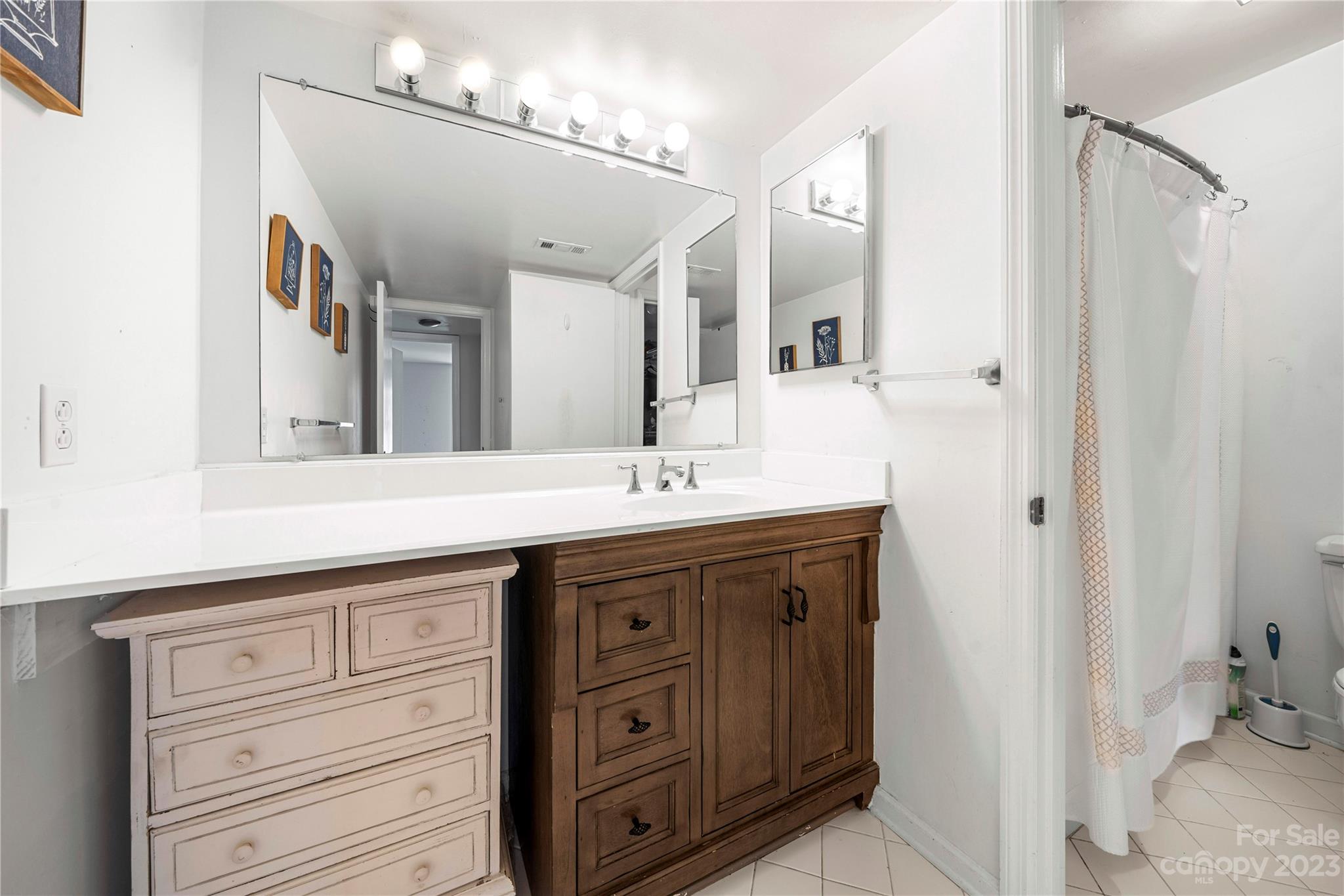3520 Colony Road, Unit G Charlotte, NC 28211 - Photo 17 of 19 a bathroom with a granite countertop sink vanity and mirror