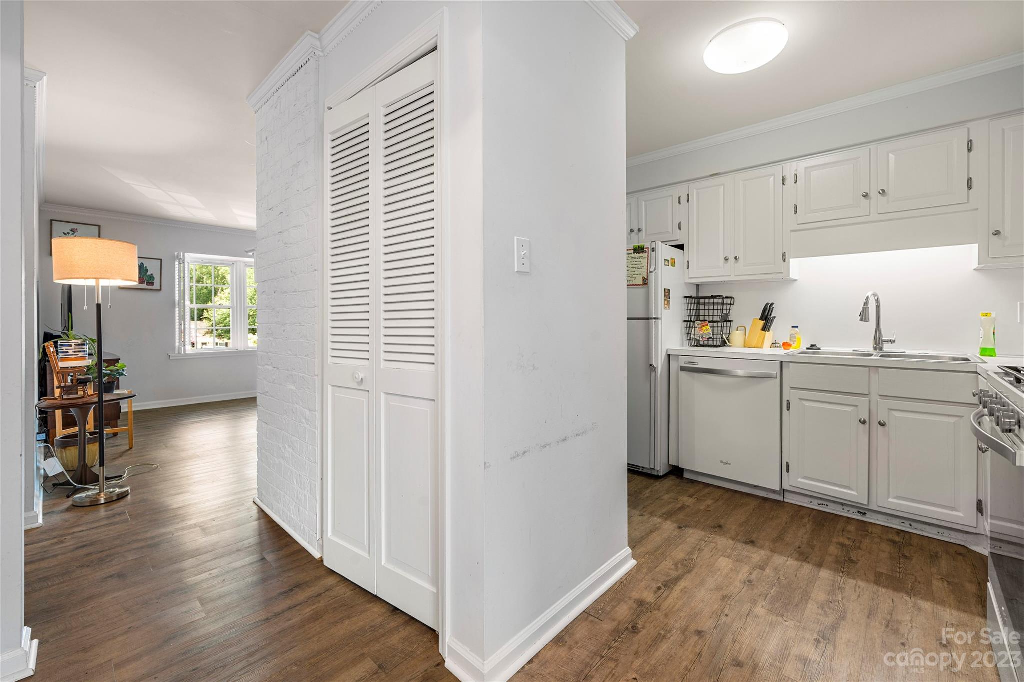 3520 Colony Road, Unit G Charlotte, NC 28211 - Photo 6 of 19 a kitchen with cabinets and wooden floor