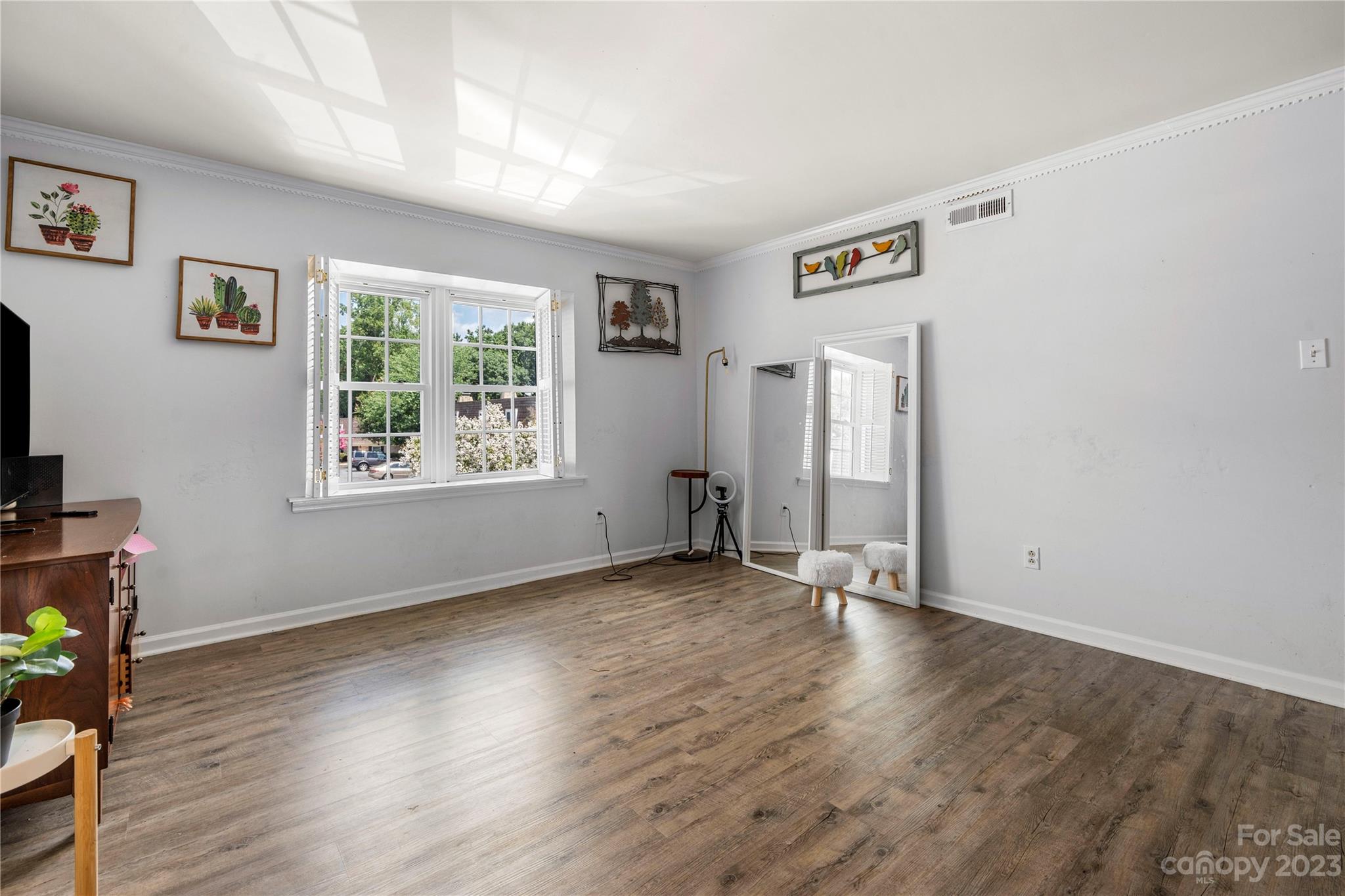3520 Colony Road, Unit G Charlotte, NC 28211 - Photo 10 of 19 a view of an empty room with wooden floor and a window
