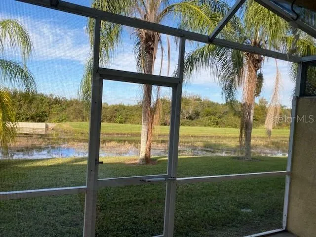 a view of an empty room with a fireplace and windows