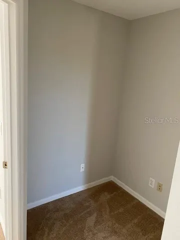 a view of a hallway to rooms