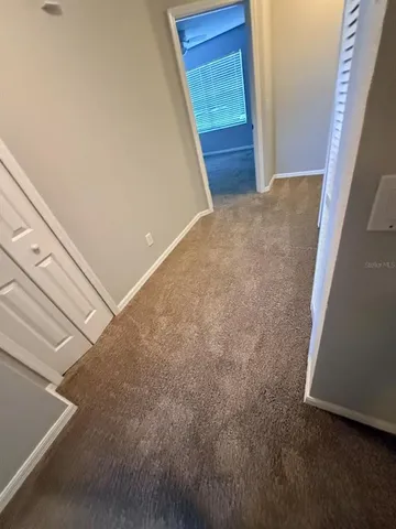 a view of an empty room and a window