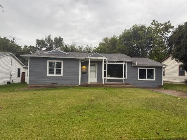 a backyard of a house with table and chairs