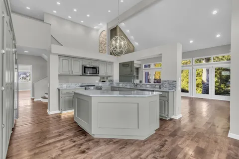 a kitchen with stainless steel appliances granite countertop a sink and stove