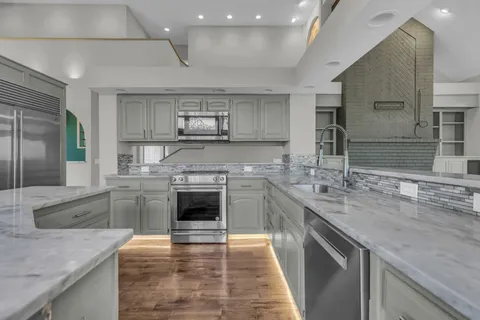 a view of a kitchen with a sink and a fireplace