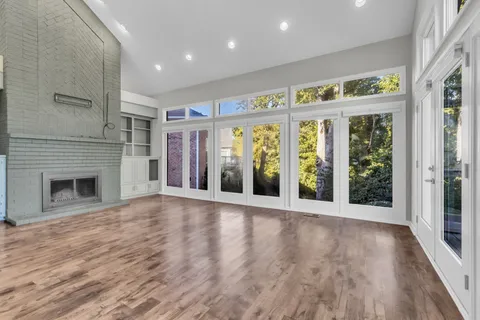 a living room with furniture fireplace and a large window