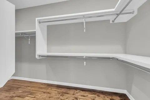 an empty room with closet and windows