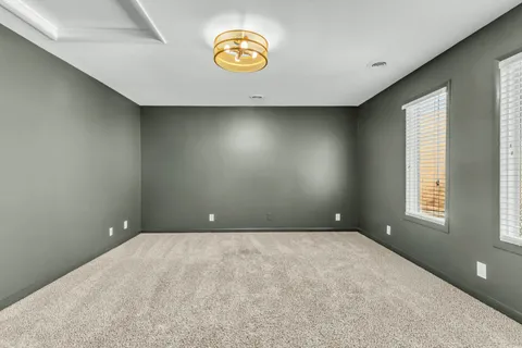 an empty room with windows and city view