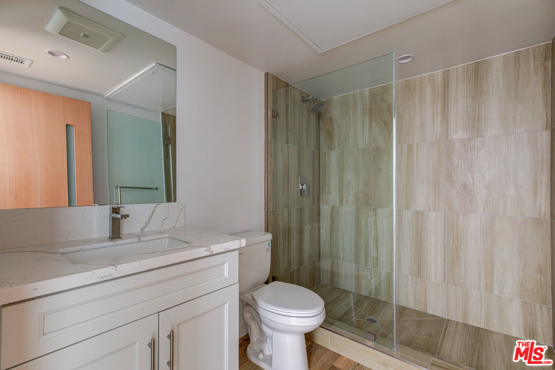 11906 Rochester Avenue Los Angeles, CA 90025 - Photo 11 of 13 a bathroom with a sink toilet and shower