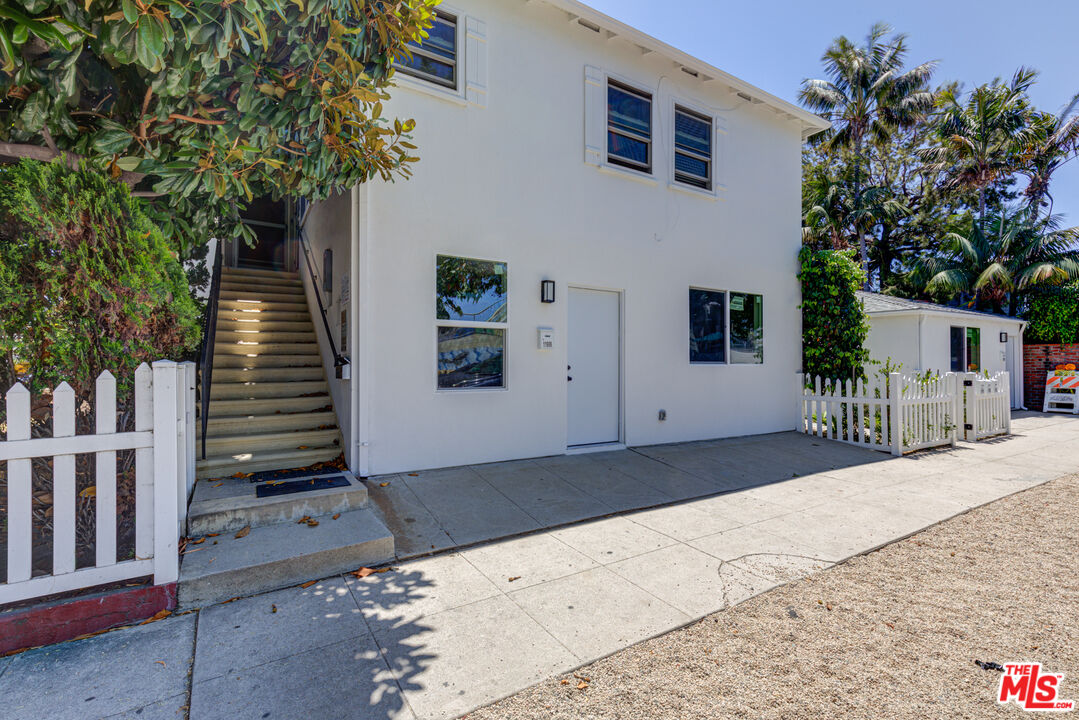 11906 Rochester Avenue Los Angeles, CA 90025 - Photo 2 of 13 a front view of a house with a yard