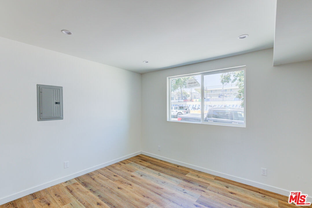 11906 Rochester Avenue Los Angeles, CA 90025 - Photo 10 of 13 a view of an empty room with wooden floor and a window