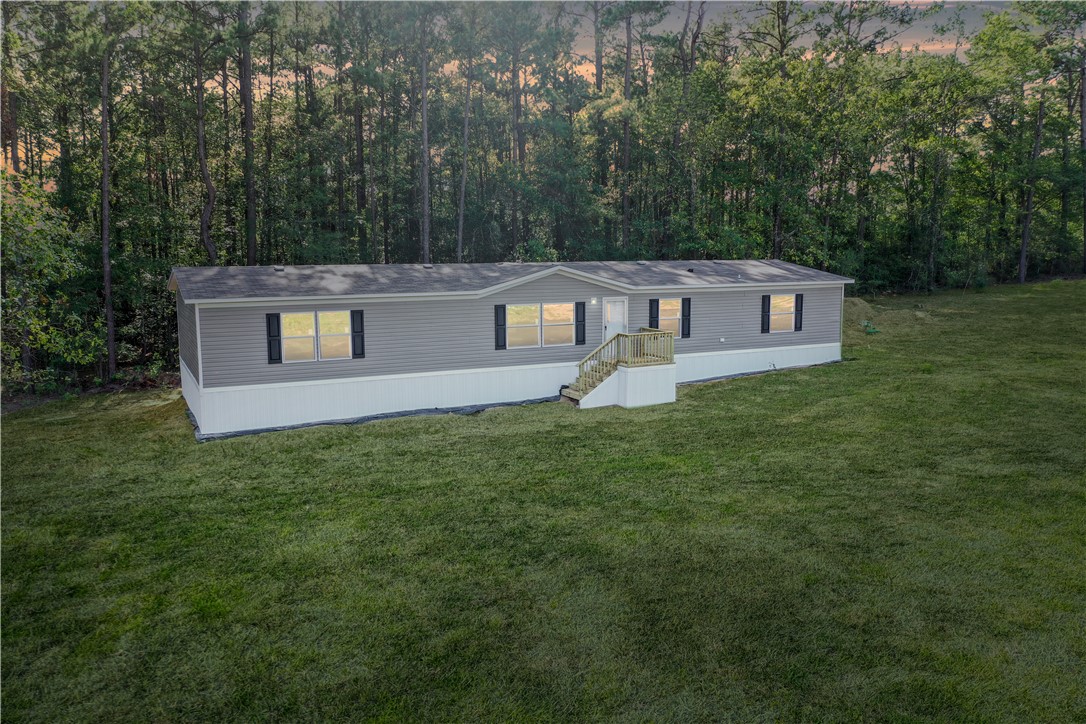 4845 Long Shadows Road Navasota, TX 77868 - Photo 4 of 13 5 bedroom home on 1 acre lot backs up to mature wooded lot. Grass is digitally enhanced