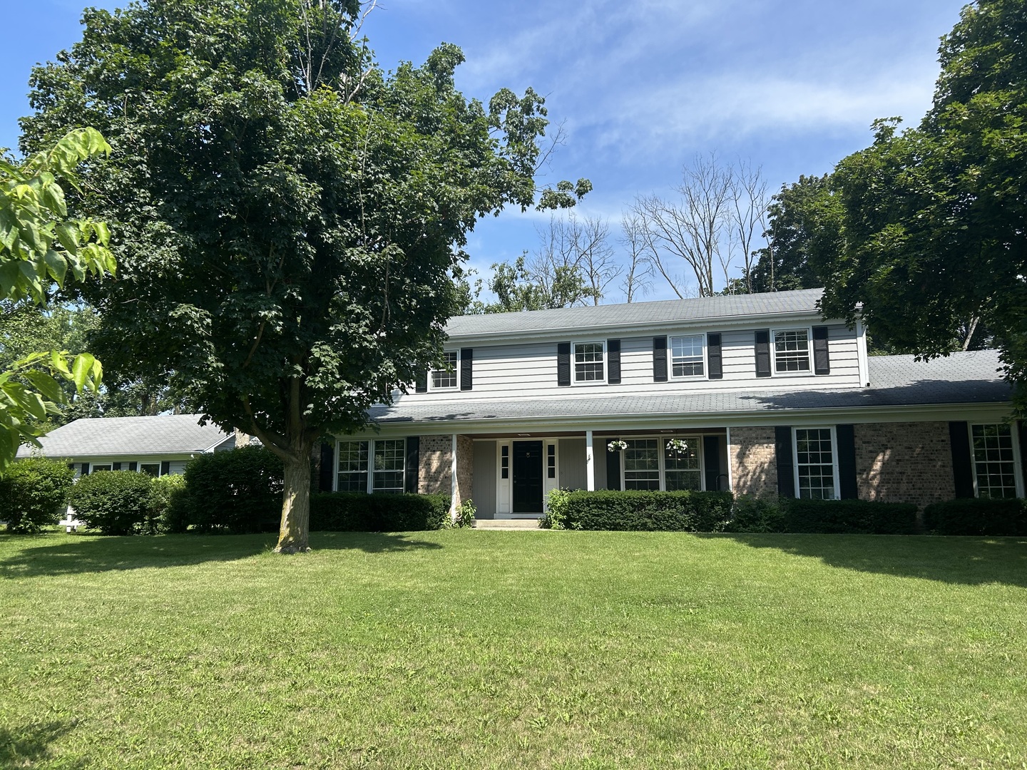a front view of a house with a yard table and chairs