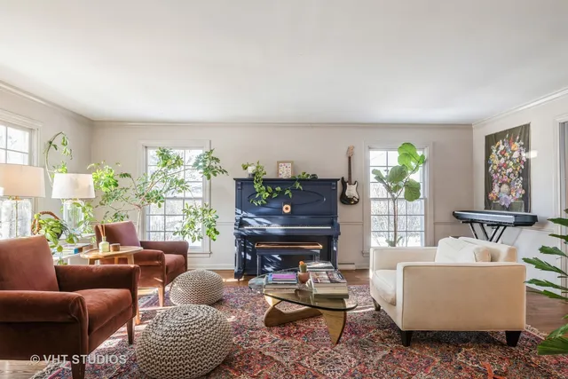 a living room with furniture and a potted plant