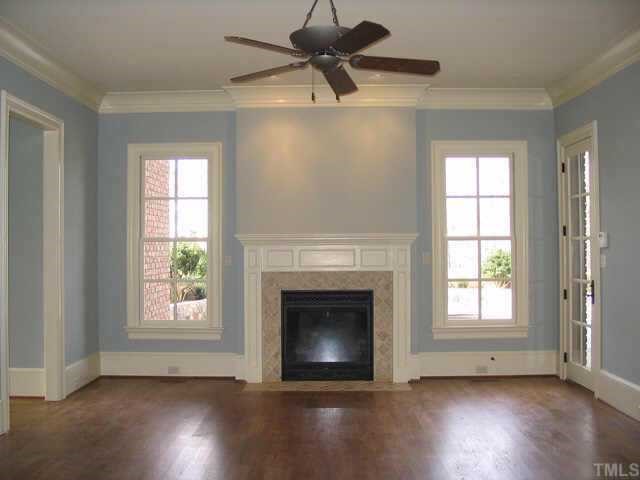 3124 Cone Manor Lane Raleigh, NC 27613 - Photo 5 of 10 a view of an empty room with wooden floor fireplace and a window