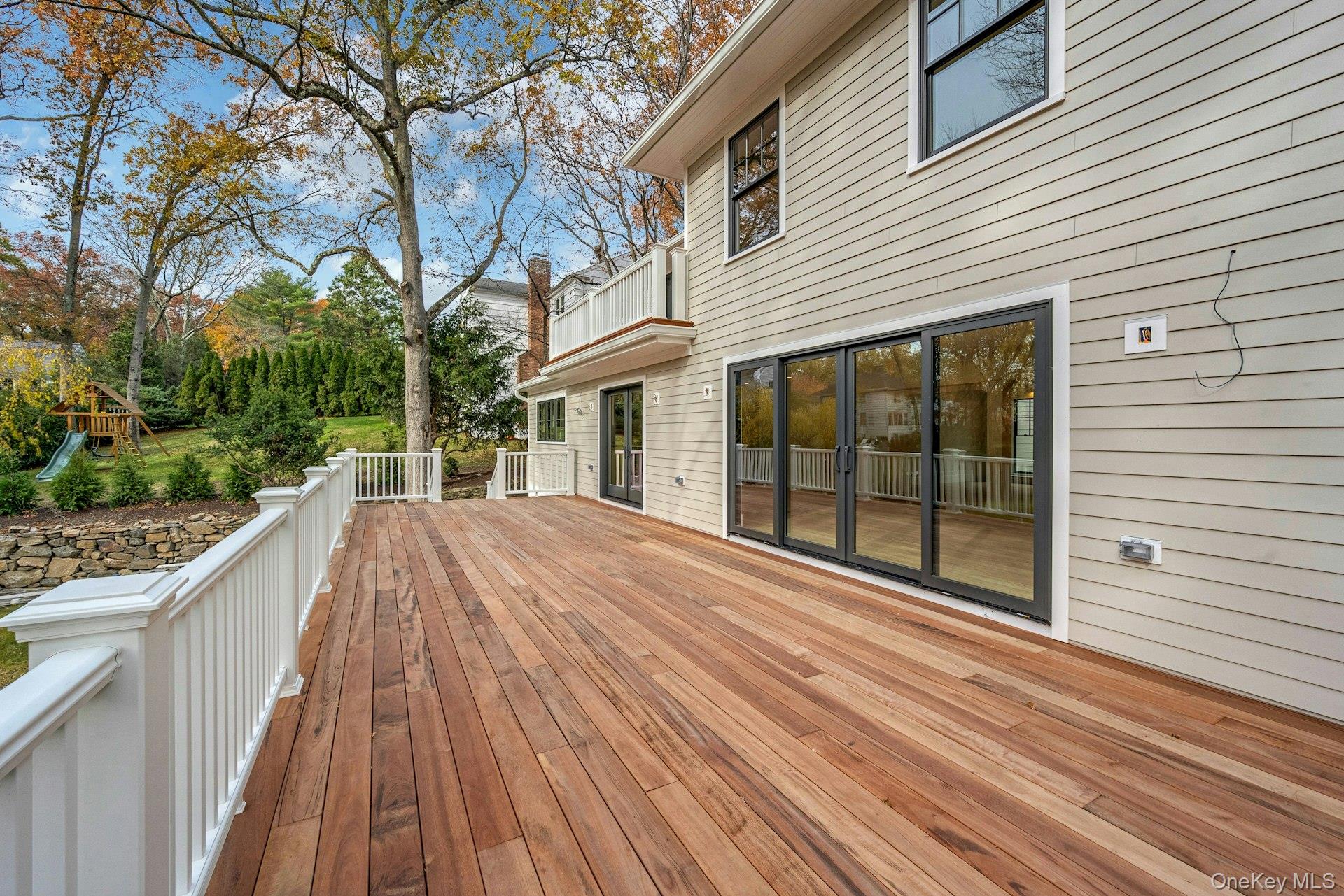 32 Sycamore Road Scarsdale, NY 10583 - Photo 13 of 50 Wooden deck with a playground