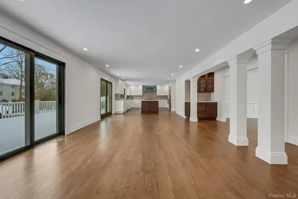 a view of entryway and hall with wooden floor