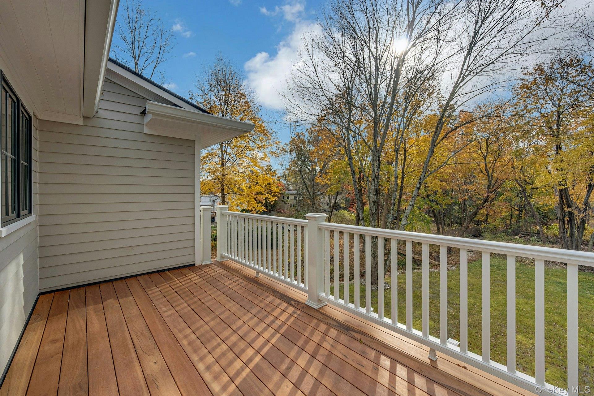 32 Sycamore Road Scarsdale, NY 10583 - Photo 16 of 50 Deck overlooking a yard on second level off of primary bedroom.
