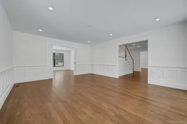 a view of room with wooden floor and floor to ceiling window