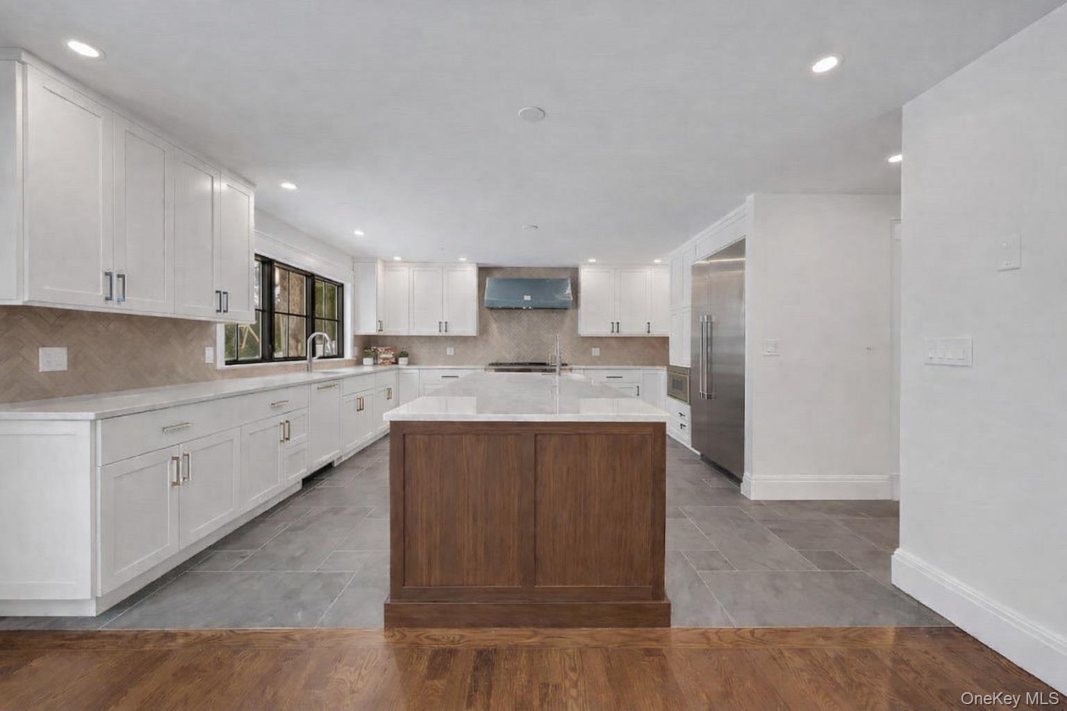 32 Sycamore Road Scarsdale, NY 10583 - Photo 7 of 48 Luxury kitchen with Thermador appliances and quartz countertops and expansive island