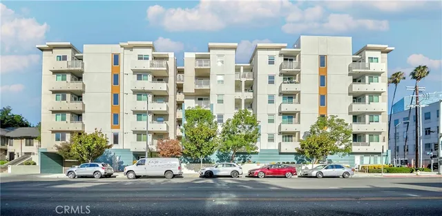 a front view of a house with lots of potted plants