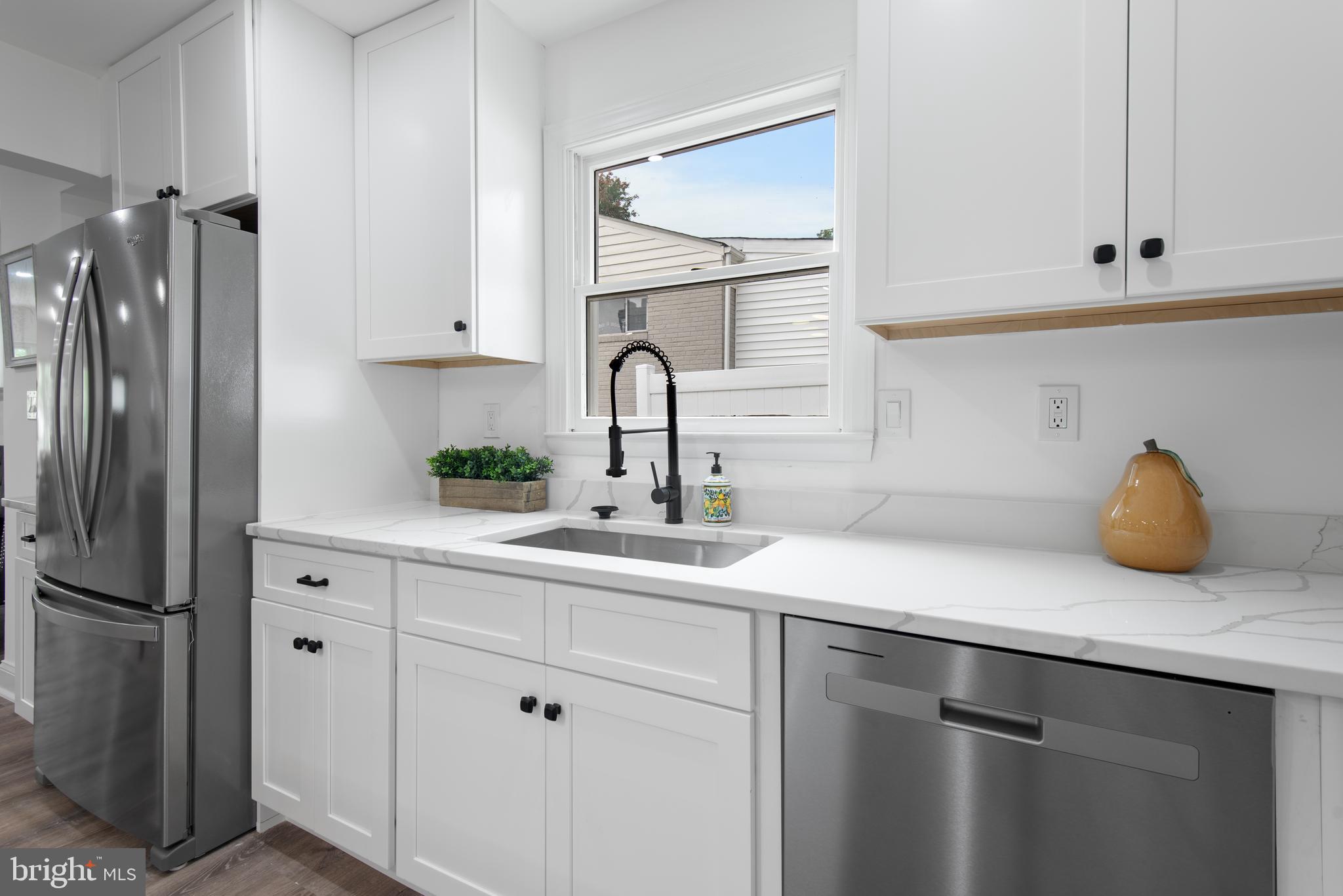 2215 Reedie Drive Silver Spring, MD 20902 - Photo 24 of 56 a kitchen with white cabinets and a refrigerator