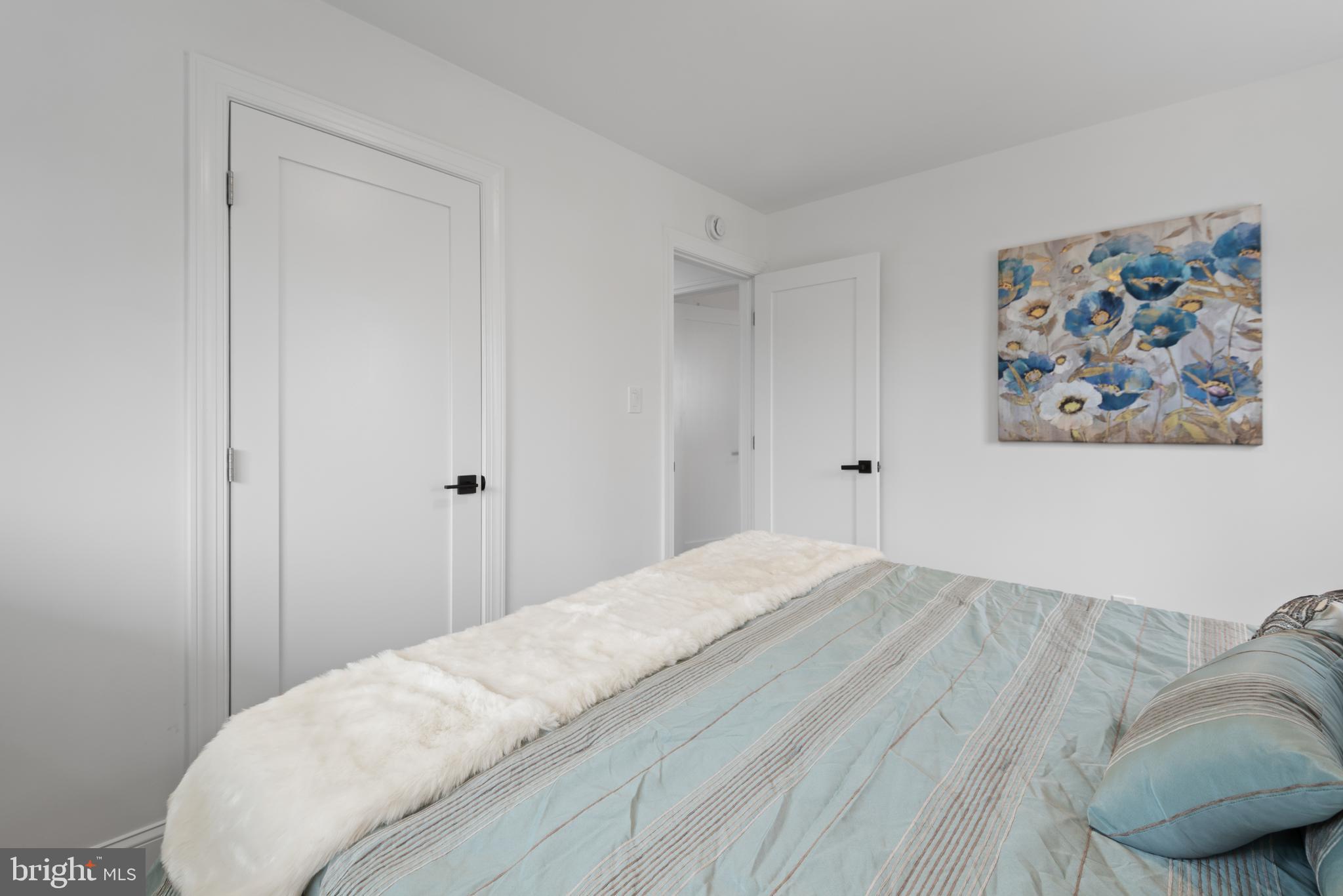 2215 Reedie Drive Silver Spring, MD 20902 - Photo 31 of 56 a bedroom with a bed and painting on the wall