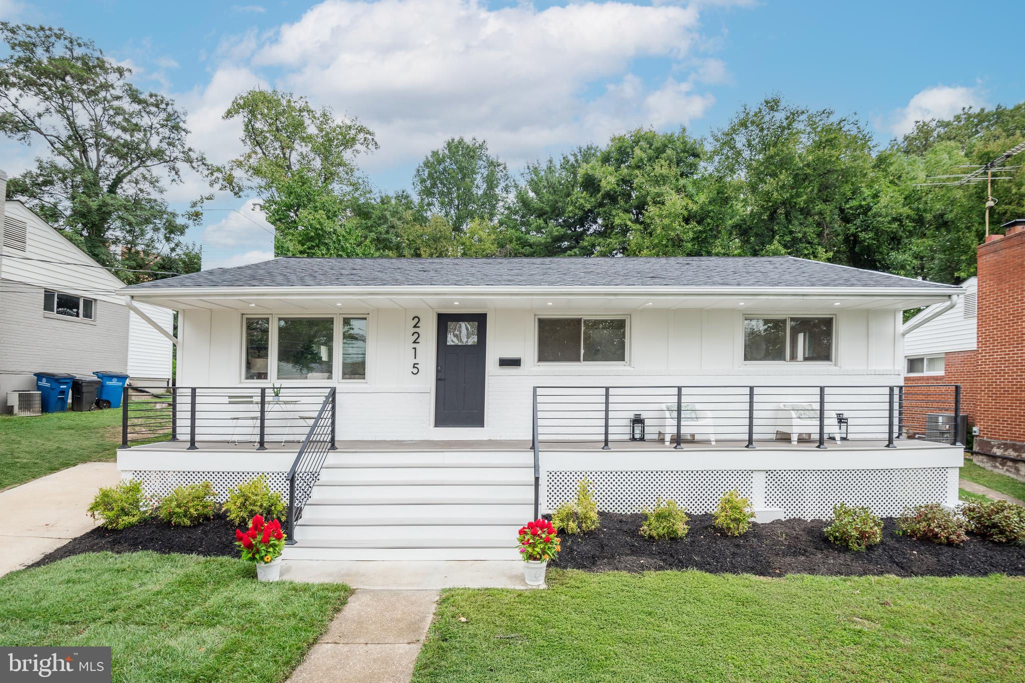2215 Reedie Drive Silver Spring, MD 20902 - Photo 5 of 56 a front view of a house with a garden and yard