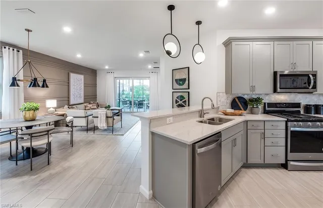 a kitchen with a sink stove and wooden floor