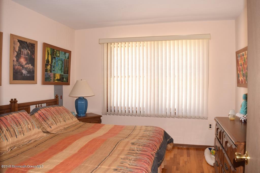 40 Compass Road Waretown, NJ 08758 - Photo 12 of 38 a bedroom with a bed and a flat screen tv