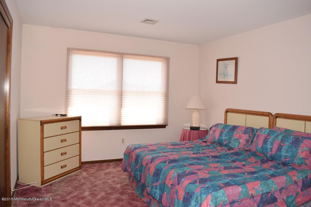 40 Compass Road Waretown, NJ 08758 - Photo 16 of 38 a bedroom with a bed and a window