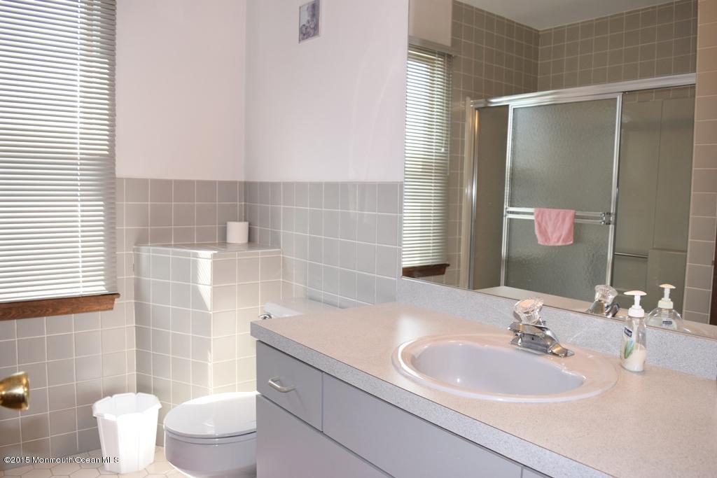 40 Compass Road Waretown, NJ 08758 - Photo 17 of 38 a bathroom with a sink and a mirror