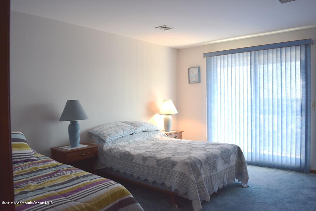 40 Compass Road Waretown, NJ 08758 - Photo 18 of 38 a bedroom with a bed and a lamp