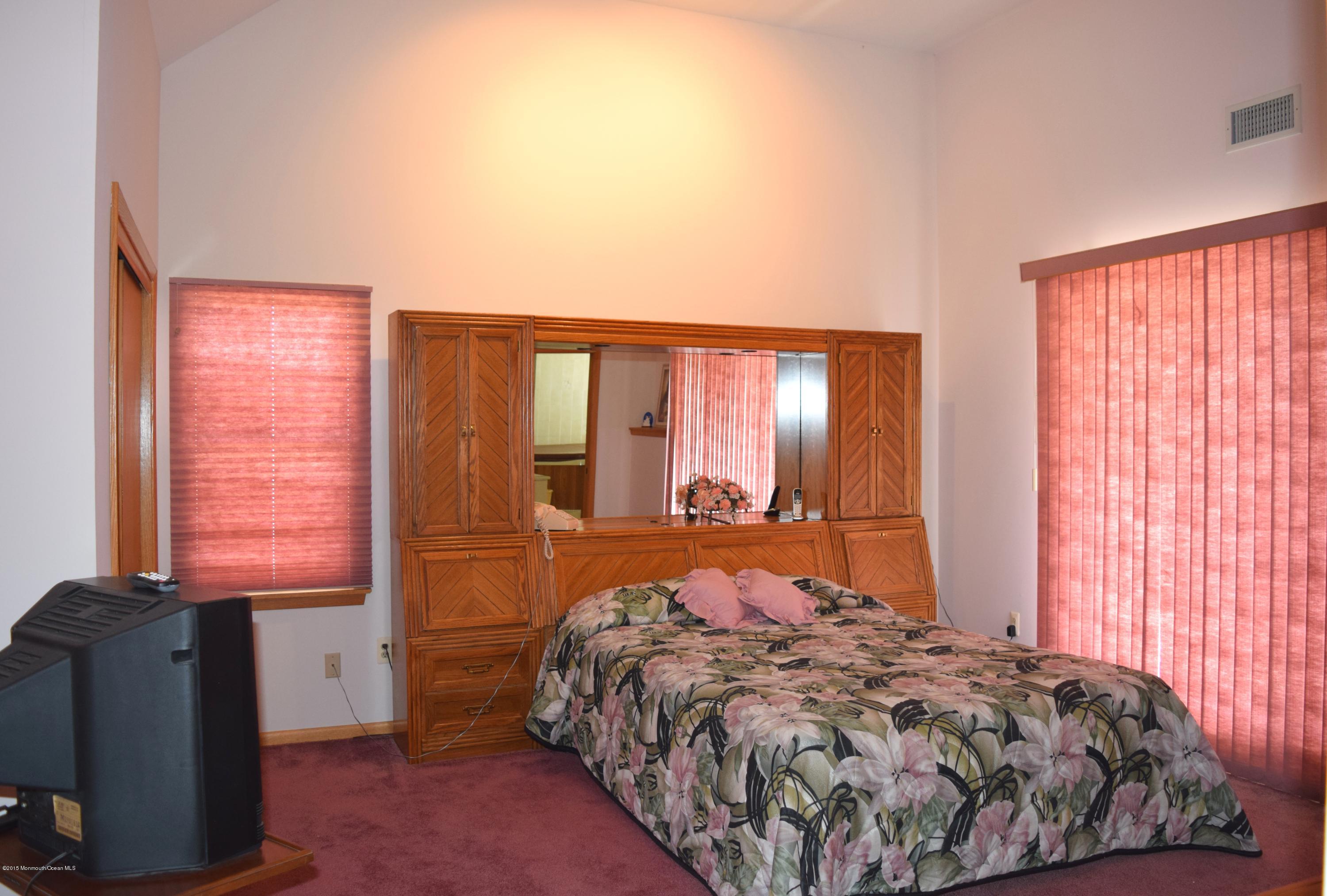 40 Compass Road Waretown, NJ 08758 - Photo 21 of 38 a bed sitting in a bedroom next to a window