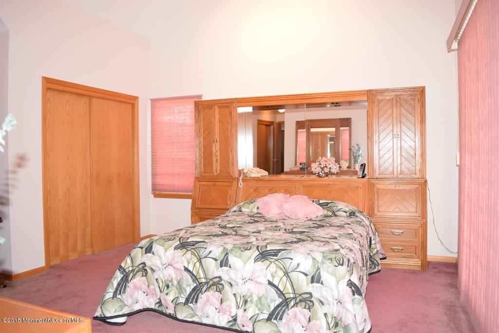 40 Compass Road Waretown, NJ 08758 - Photo 22 of 38 a bedroom with a bed and a window