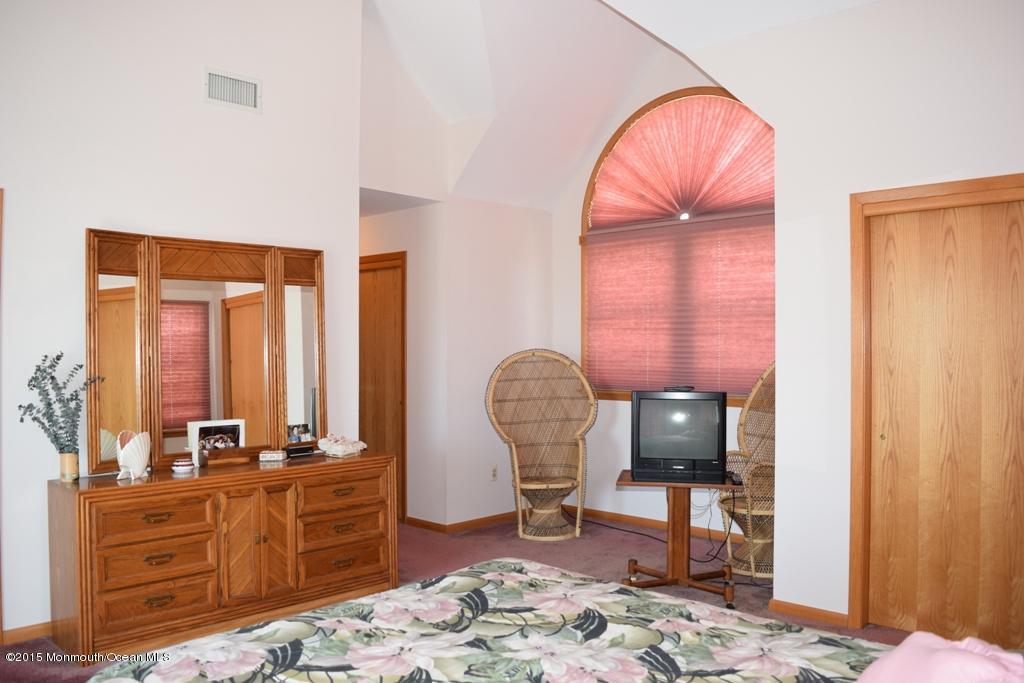 40 Compass Road Waretown, NJ 08758 - Photo 23 of 38 a room with furniture a rug and a wooden floor