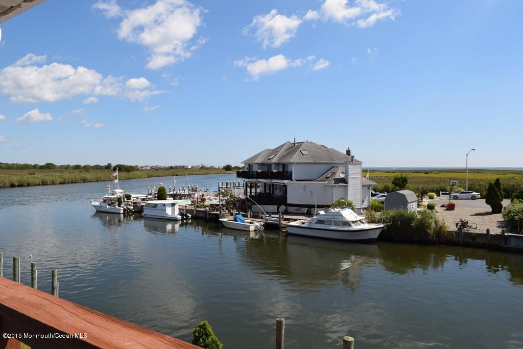 40 Compass Road Waretown, NJ 08758 - Photo 26 of 38 a view of a lake with boats and trees in the background