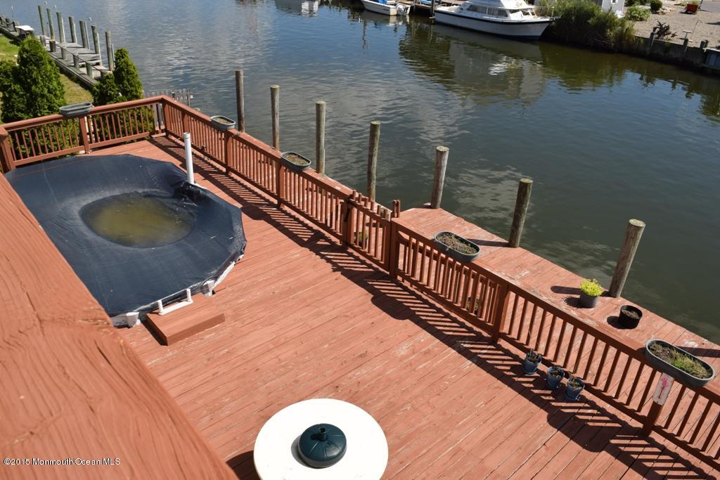 40 Compass Road Waretown, NJ 08758 - Photo 34 of 38 a balcony with chairs and wooden floor