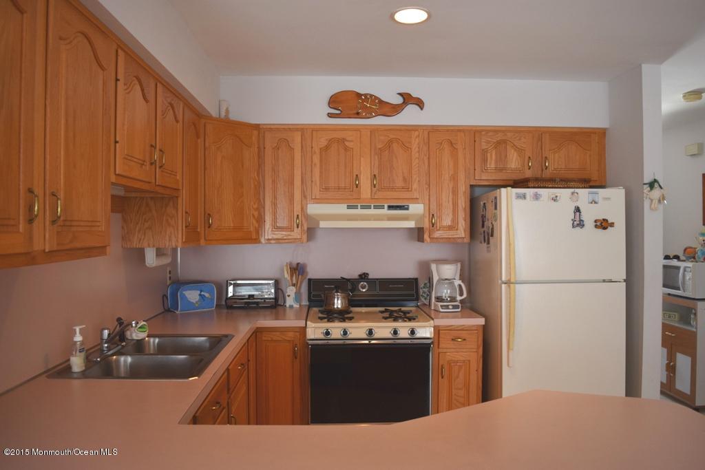 40 Compass Road Waretown, NJ 08758 - Photo 6 of 38 a kitchen with stainless steel appliances granite countertop a refrigerator a sink a stove and a refrigerator