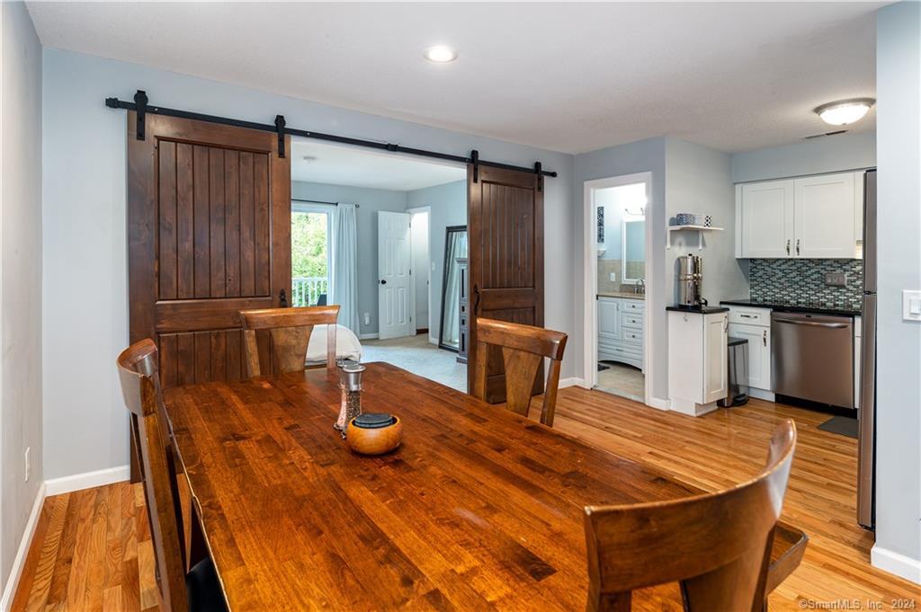 71 Aiken Street, Unit O7 Norwalk, CT 06851 - Photo 1 of 1 a room with table chairs and kitchen view