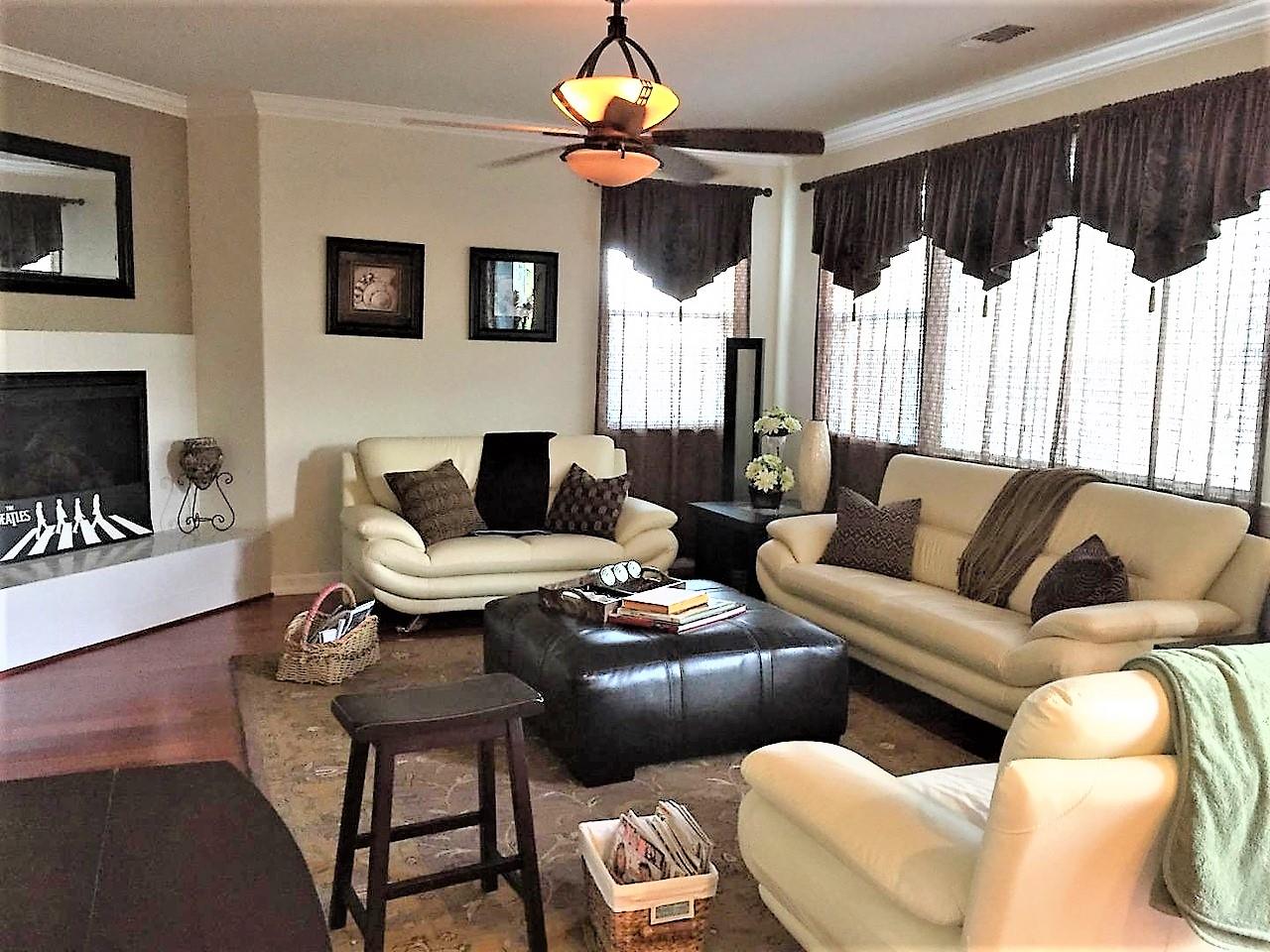 3532 Keystone Loop Discovery Bay, CA 94505 - Photo 12 of 37 a living room with furniture a fireplace and a chandelier